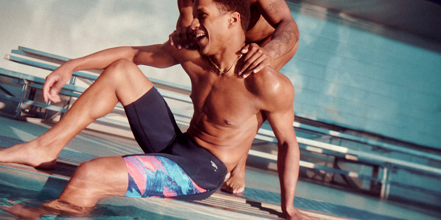 two swimmers wearing speedo swimwear next to a pool