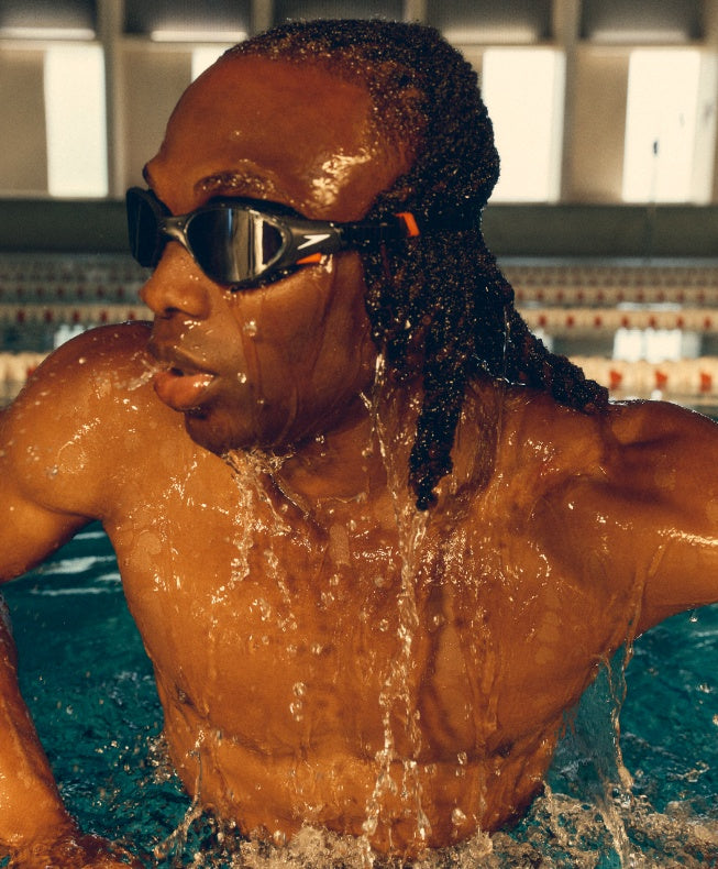 Man in Speedo Biofuse 2.0 Goggles getting out of a pool