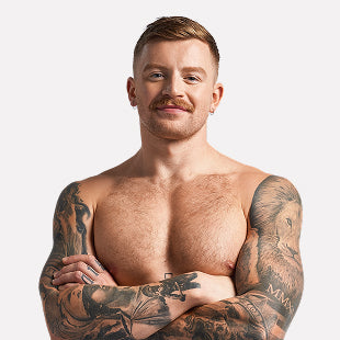 Male swimmer with tattoos posing shirtless