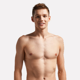Male swimmer standing shirtless smiling