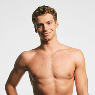 Male swimmer smiling shirtless