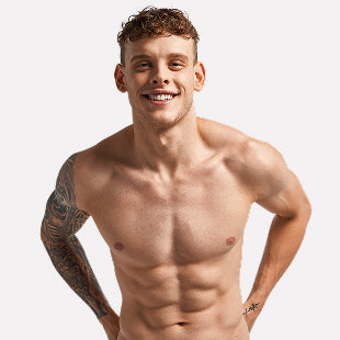 Muscular male swimmer posing shirtless